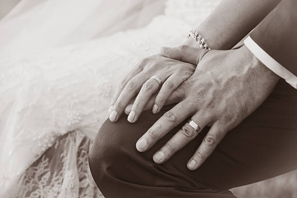 istock Newly wed couple's hands with wedding rings 589981668
