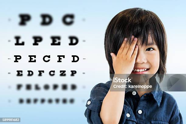 Cute Asian Boy Doing Eye Test Stock Photo - Download Image Now - Eye Exam, Child, Glaucoma