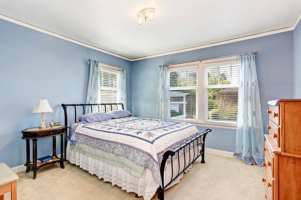 istock Bedroom interior with colorful bedding and carpet floor. 589981778