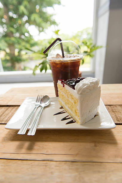 istock Ice coffee and blueberry cake on wood table,american Coffee, 589982064