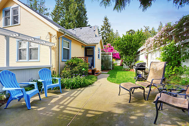 istock Yellow house backyard area with patio 589982972