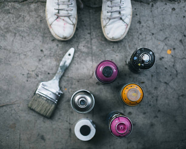 istock Spray cans and brush on sidewalk 589984438