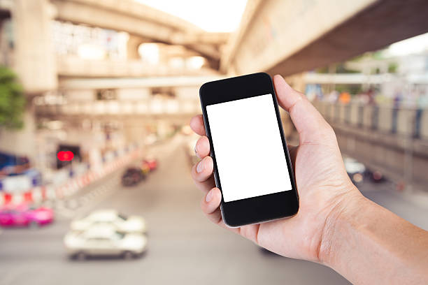 istock Person using smartphone white screen holder on hand with  blurry 589985266