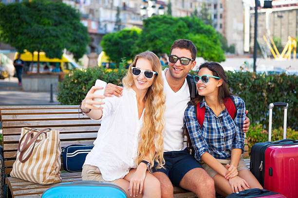 istock Happy tourists making selfei by the smart phone 589985620