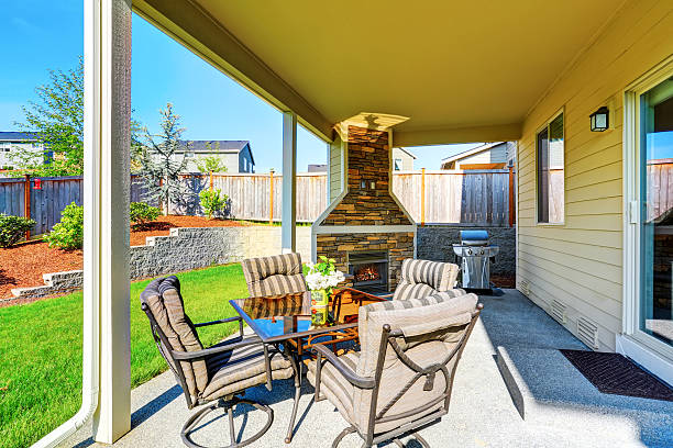 istock Cozy covered patio with stone trim fireplace. 590033000