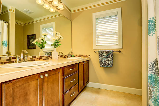 istock Bright elegant bathroom interior with fresh flowers 590033062