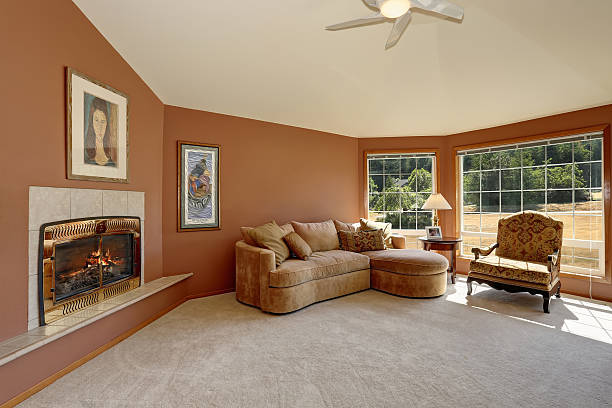 istock Cozy living room interior with tile fireplace and big windows. 590033092