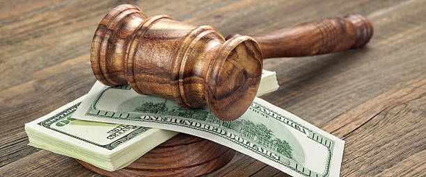 istock Stack Of Banknotes With Judges Or Auctioneers Gavel Or Hammer 590033200