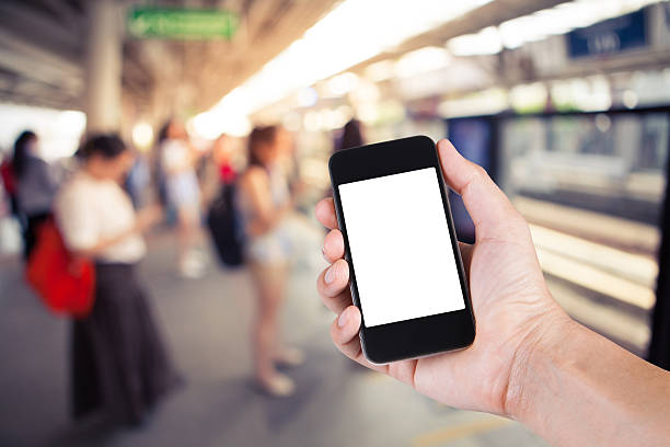 istock Person using smartphone white screen holder on hand with  blurre 590034732
