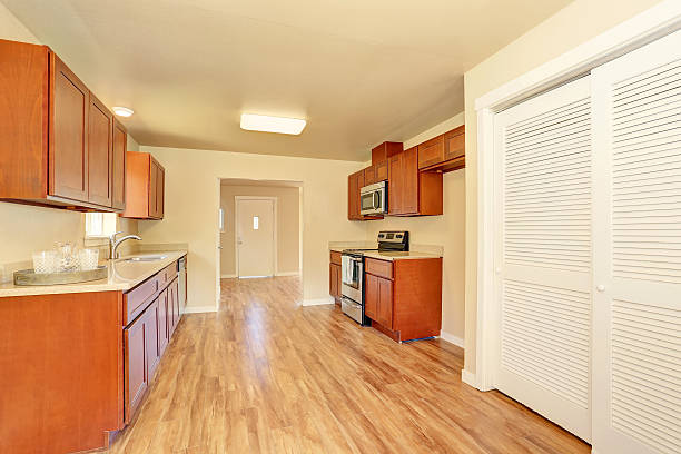 istock Open floor plan kitchen room interior with wooden cabinets 590035526
