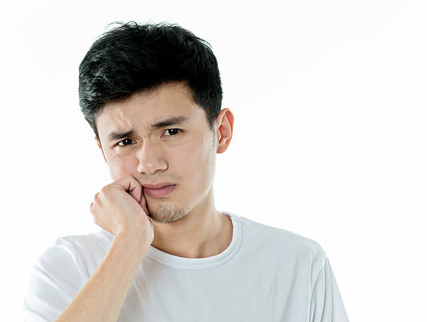 istock Young asian man suffering from toothache 590035612