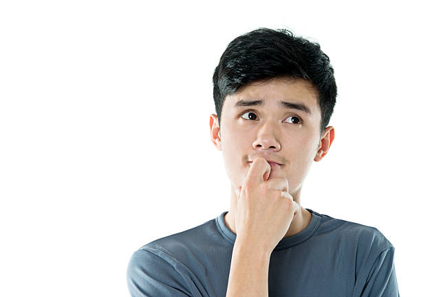 istock Thoughtful young asian man against white background 590036106