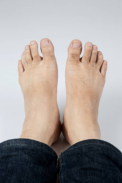 istock Male feet on gray background 590036228