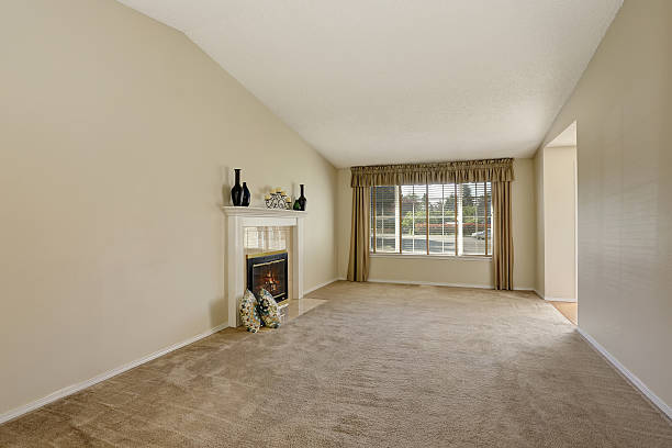 istock Empty living room interior in creamy tones with vaulted ceiling 590037744