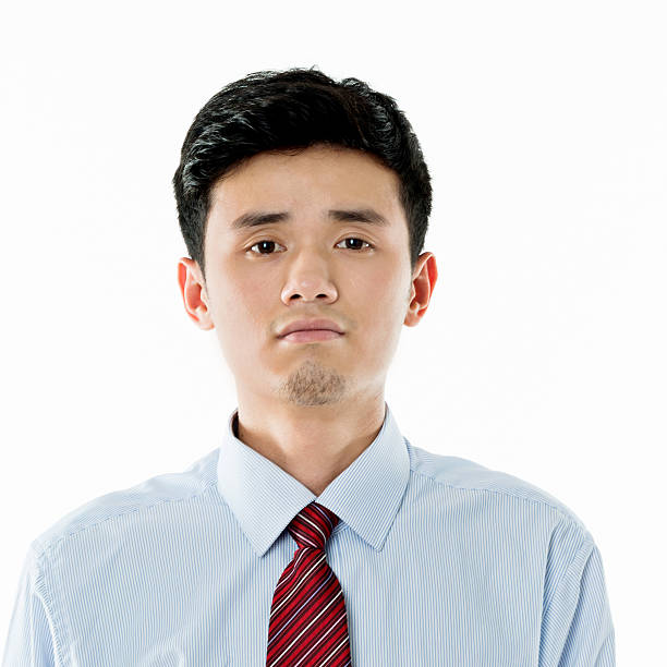 istock Smiling asian businessman standing against white background 590038150