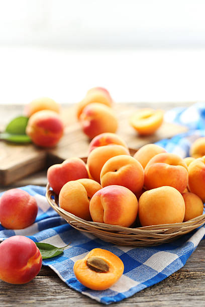 istock Ripe apricots fruit on grey wooden table 590038526