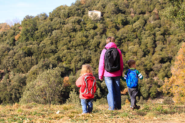 istock mother with two kids travel in mountains 590039740