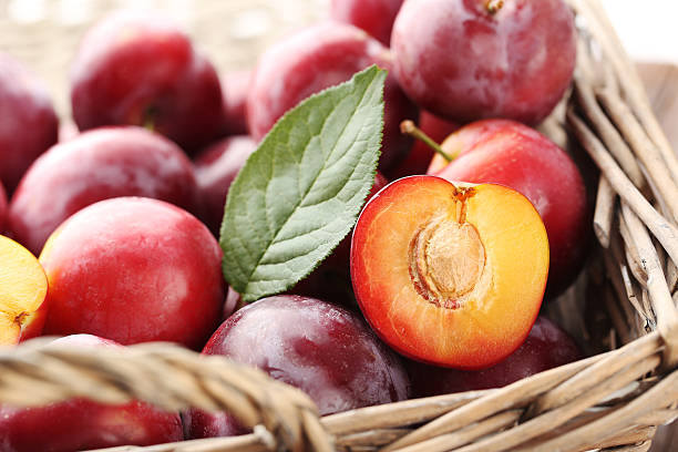 istock Fresh and ripe plums in basket 590039988