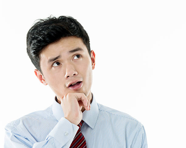 istock Thoughtful young asian businessman against white background 590040416