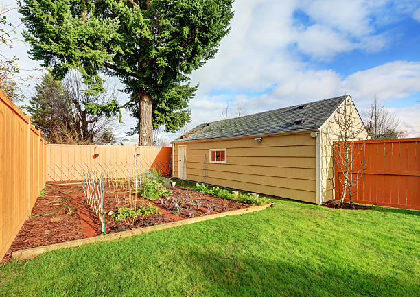 istock Small vegetable garden with risen beds in the fenced backyard 590040742
