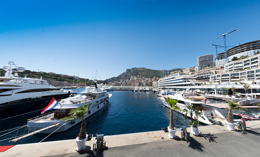 Monte Carlo, Monaco - August 8, 2016: A view of boats in the marina in Monaco, a tiny state on France's Mediterranean coastline, Côte d'Azur. Known for luxury boats, casinos and the Grand Prix track. Various boats signs and people in the background.