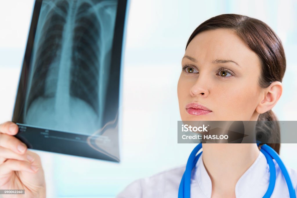 Female doctor looking at a lungs or torso x-ray, fluorography Adult Stock Photo