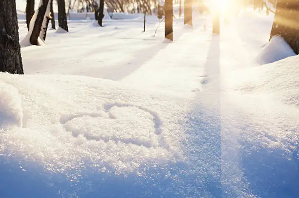 Shape of heart on the snow. Winter landscape