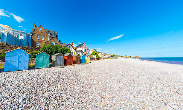 Beach Huts in Budleigh Salterton in Devon Beach Huts and multiple houses (many and not the focus) by the beach in Budleigh Salterton, a seaside town near Exmouth and Exeter in Devon, UK.  exmouth western australia photos stock pictures, royalty-free photos & images