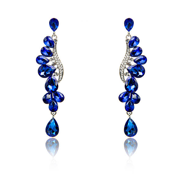 istock Pair of sapphire earrings isolated on white 590042926