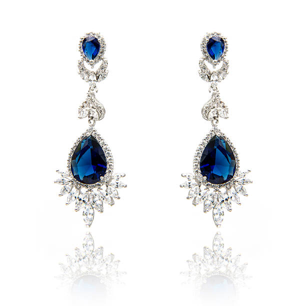 istock Pair of sapphire earrings isolated on white 590043298
