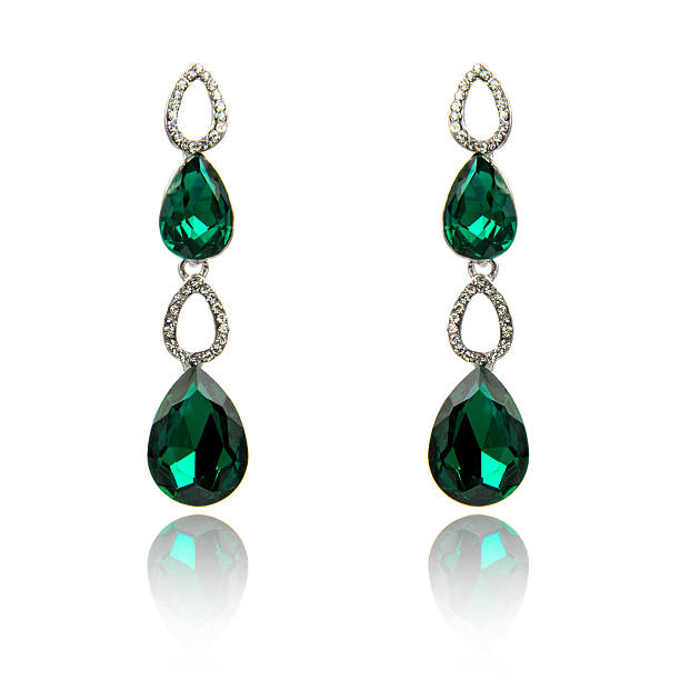istock Pair of emerald earrings isolated on white 590044554