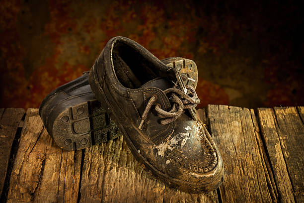 istock Still life with black leather shoes on wooden table 590044556