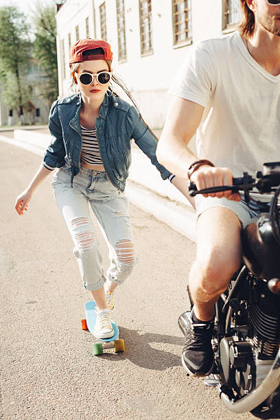 istock young people skateboarding together on road 590045152