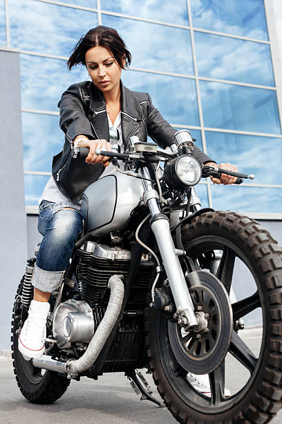 istock Biker woman in leather jacket on motorcycle 590045798
