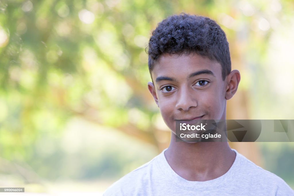 Smiling Teenage Mixed Race Boy Sincere mixed race teenager Teenage Boys Stock Photo