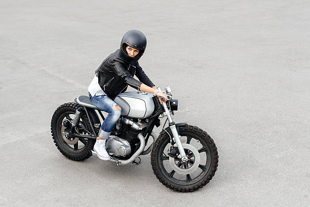 istock Biker woman in leather jacket on motorcycle 590046072