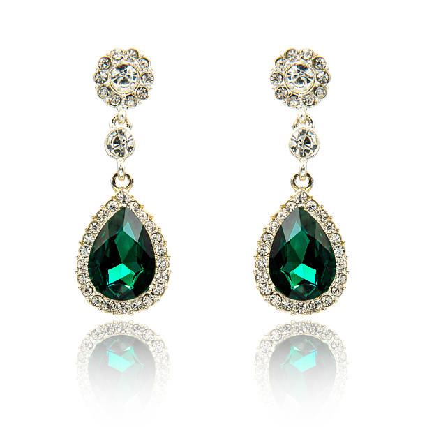 istock Pair of emerald earrings isolated on white 590046082