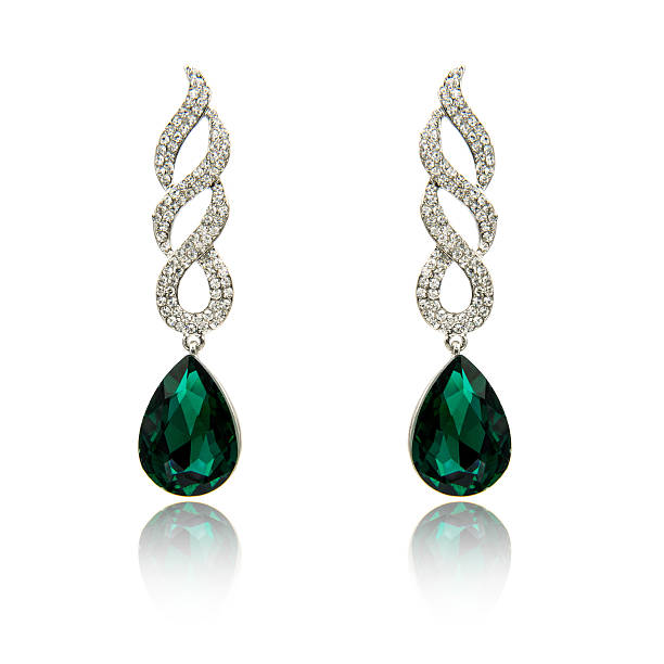 istock Pair of emerald earrings isolated on white 590046260