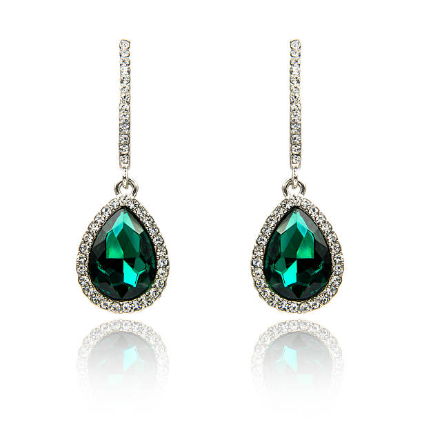 istock Pair of emerald earrings isolated on white 590046432