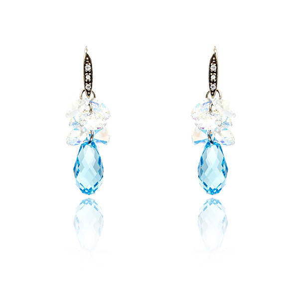 istock Pair of sapphire earrings isolated on white 590047448