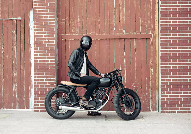 Biker and vintage custom motorcycle stock photo