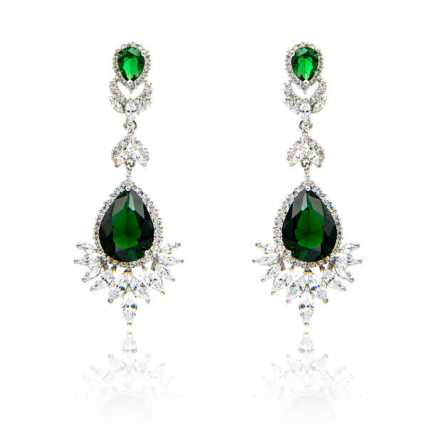 istock Pair of emerald earrings isolated on white 590047514