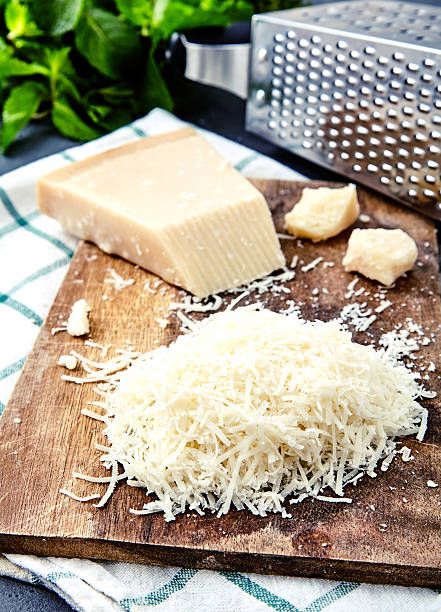 istock Piece of a parmesan and grated cheese 590047666