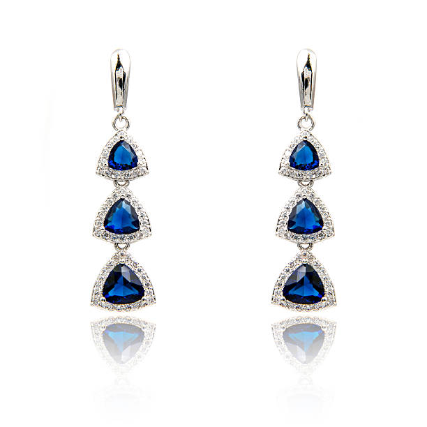 istock Pair of sapphire earrings isolated on white 590047750