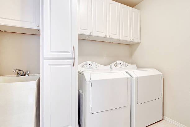 istock White laundry room with washer and dryer. 590047812