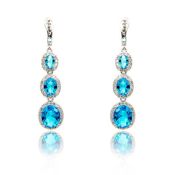 istock Pair of sapphire earrings isolated on white 590047882