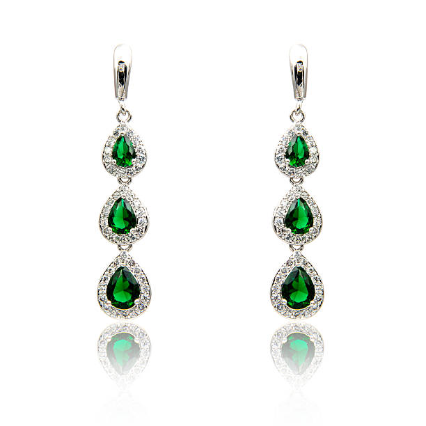 istock Pair of emerald earrings isolated on white 590048362