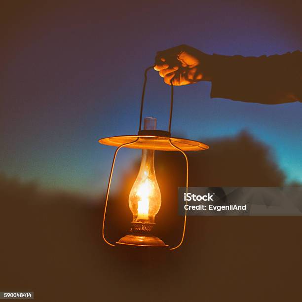 Hand Holds A Large Lamp Outdoors In The Dark Stock Photo - Download Image Now - Holding, Candle, Lantern