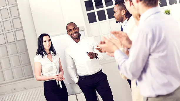 Photo of Clapping business people