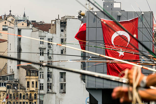 istock Galata bridge and fishermen - with Turkish Flag 590048832